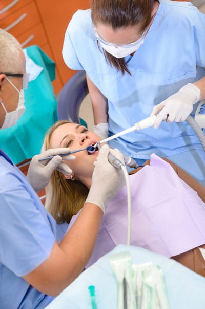 A female patient undergoes an emergency dental procedure. 